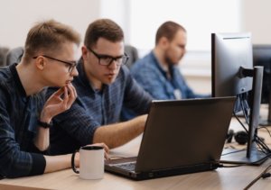 3 Person working with laptop and mug